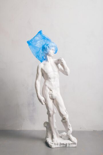 White nude sculpture covered blue plastic on head 3683191